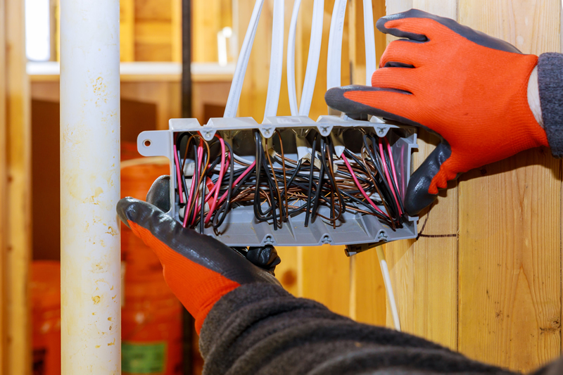 Hands holding electrical components